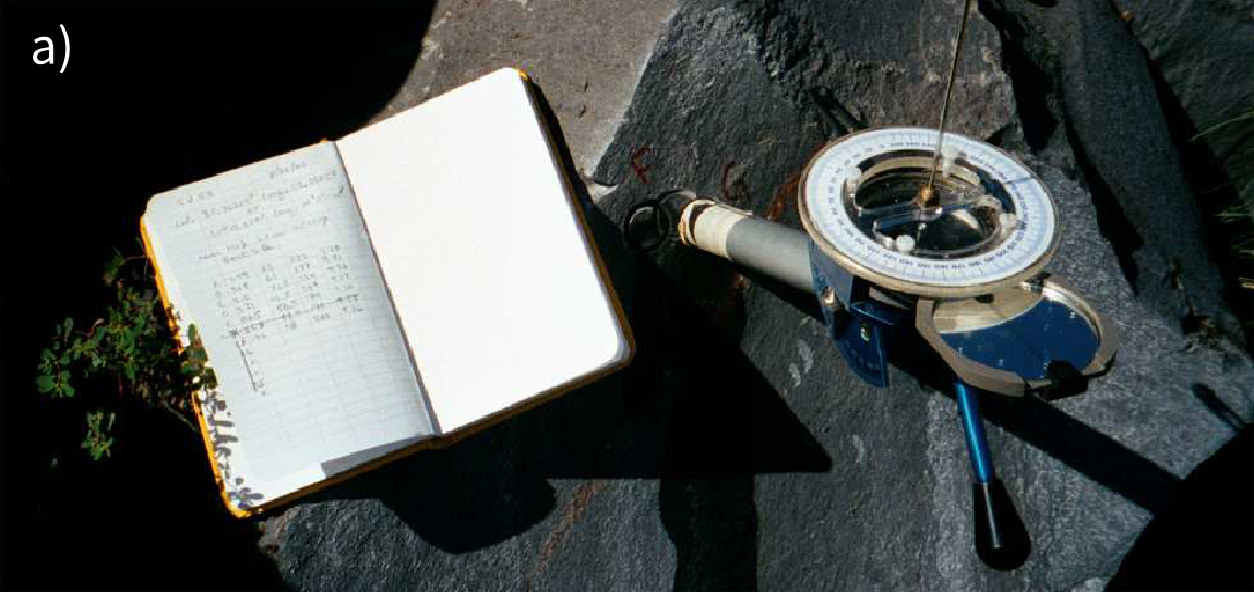 Photo of a Pomeroy orientation device with sun compass gnomon inserted into a core hole and field notebook resting on a rock outcrop.